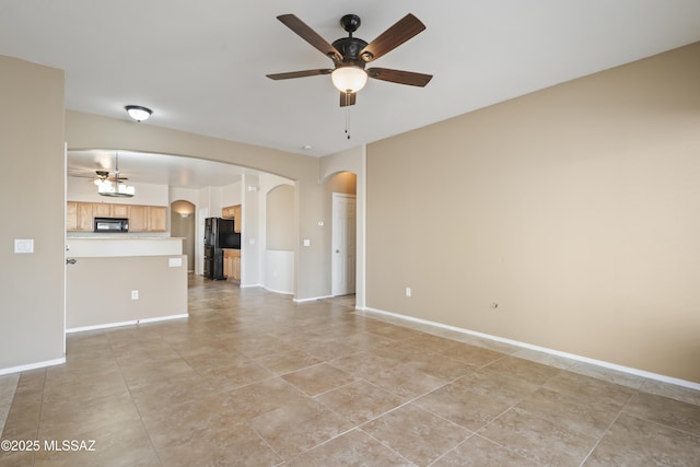 unfurnished living room with ceiling fan and light tile patterned floors