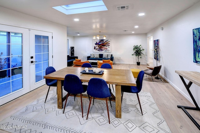 dining area featuring light hardwood / wood-style floors and french doors