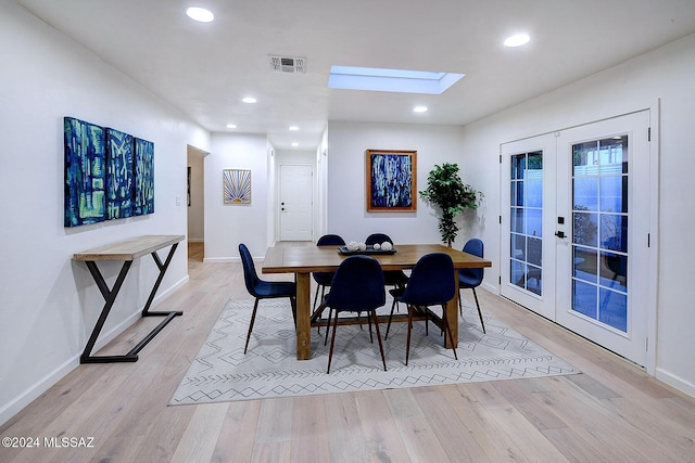 dining room featuring french doors and light hardwood / wood-style flooring