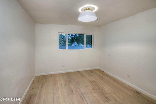 spare room with light wood-type flooring