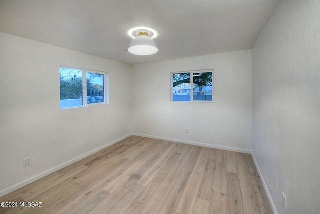 unfurnished room with light wood-type flooring