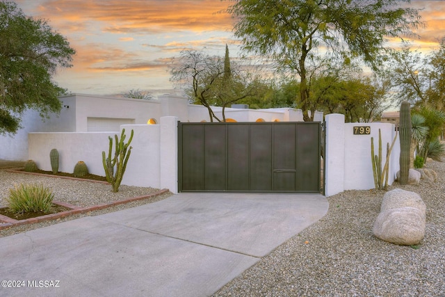 view of gate at dusk