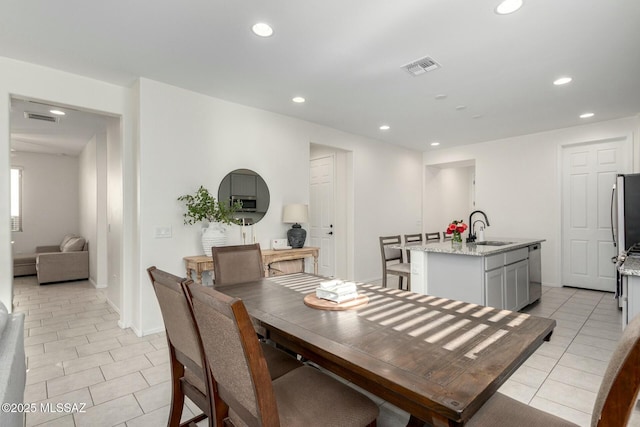 tiled dining room with sink