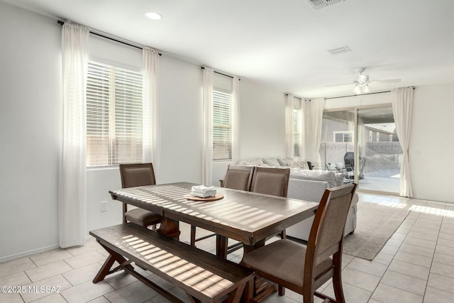 tiled dining area featuring ceiling fan