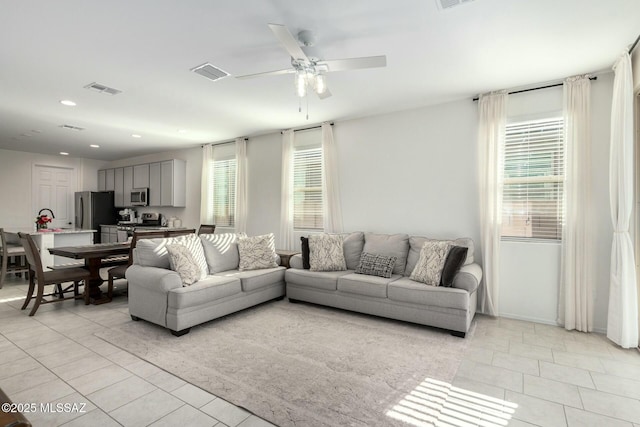 tiled living room featuring ceiling fan