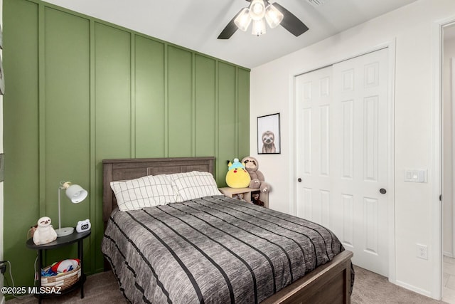 bedroom featuring a closet, ceiling fan, and carpet