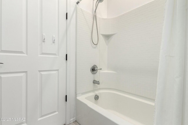 bathroom with shower / bath combination with curtain