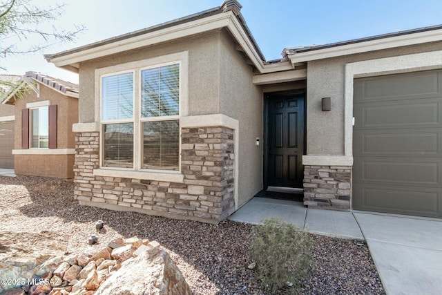 view of exterior entry featuring a garage