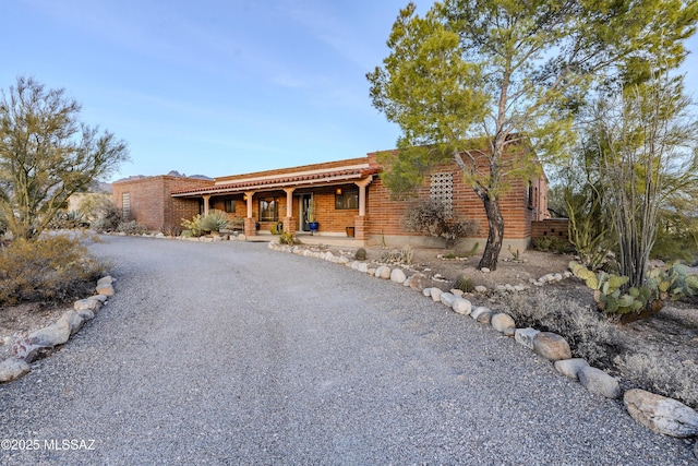 view of front of property featuring covered porch and driveway