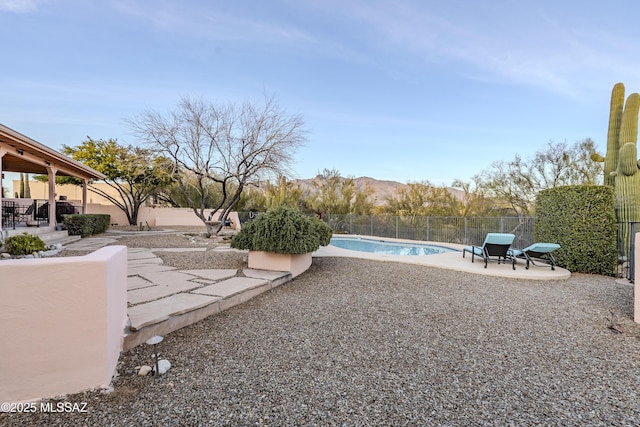 view of yard with a fenced backyard, a fenced in pool, and a patio