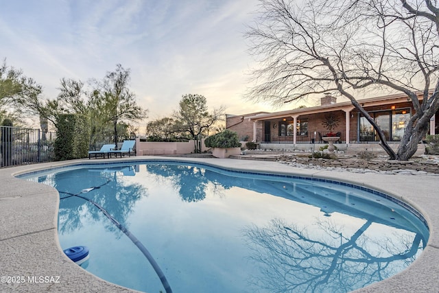 view of pool with a fenced in pool, a patio area, and fence