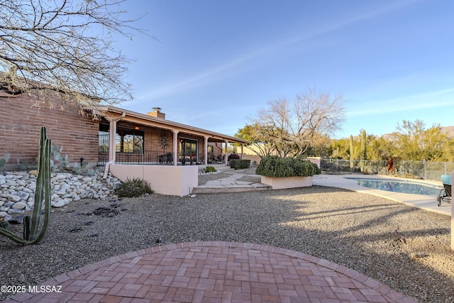 view of yard featuring a patio, fence private yard, and an outdoor pool