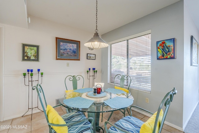 dining area featuring light tile patterned floors, visible vents, and baseboards