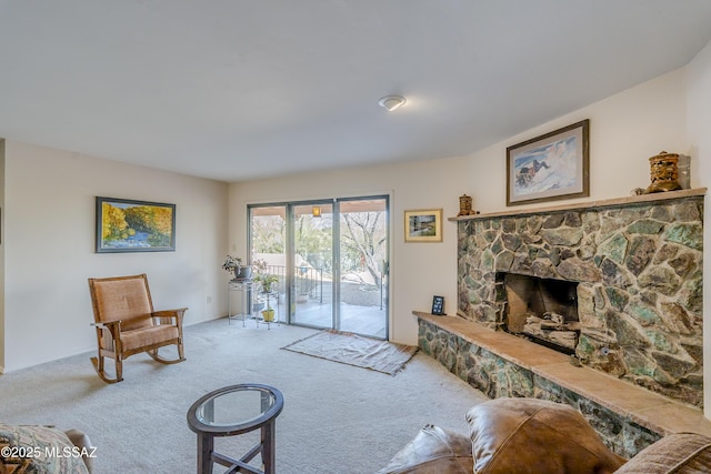 carpeted living area with a fireplace