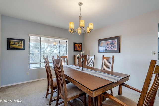 carpeted dining area with baseboards and an inviting chandelier