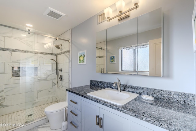 bathroom featuring visible vents, toilet, a stall shower, and vanity