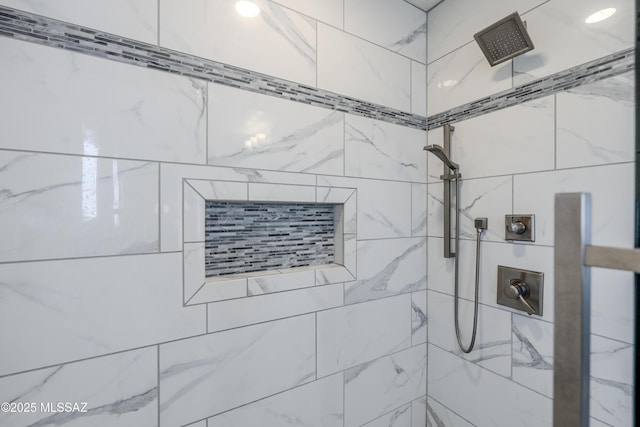 interior details featuring a tile shower