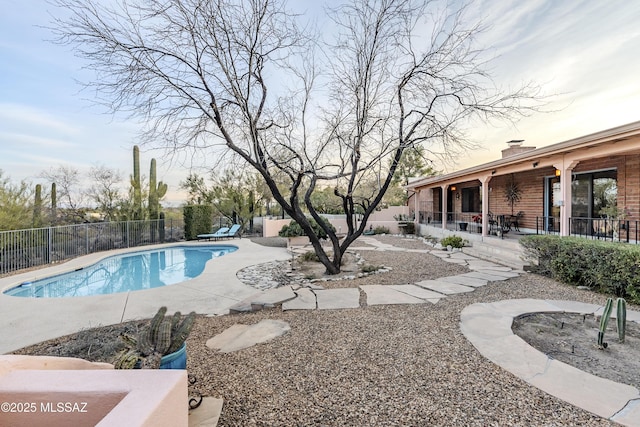 view of swimming pool with a fenced in pool, a patio, and fence