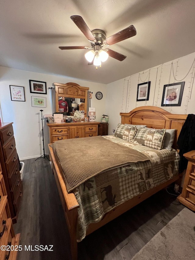 bedroom with ceiling fan and dark hardwood / wood-style flooring