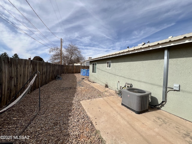 view of side of home featuring a patio area and central AC unit