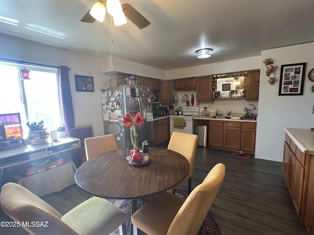 dining room featuring ceiling fan, sink, and dark hardwood / wood-style floors