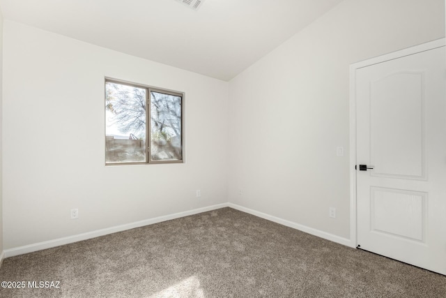 unfurnished room with vaulted ceiling and carpet