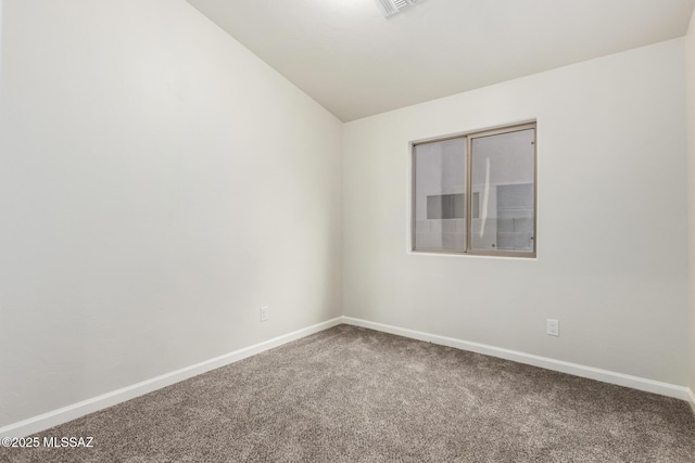 carpeted spare room with lofted ceiling