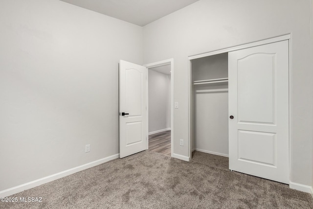 unfurnished bedroom featuring carpet floors and a closet