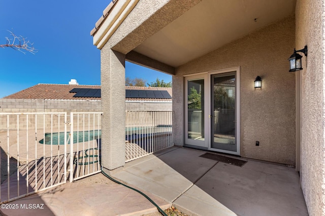 view of patio with a fenced in pool