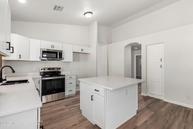 kitchen featuring a kitchen island, sink, white cabinetry, and appliances with stainless steel finishes