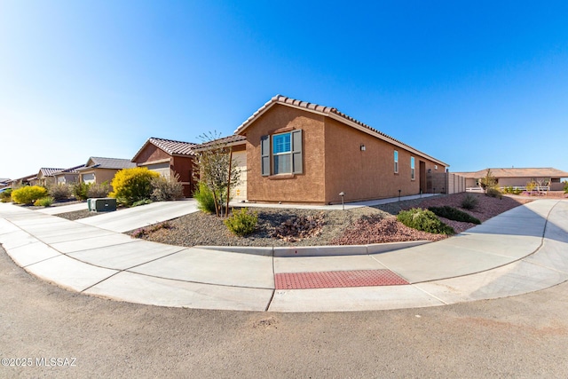 view of front of home with stucco siding and a tile roof