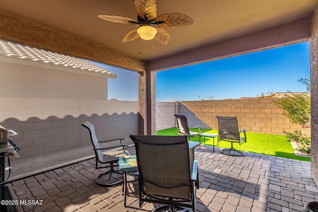 view of patio featuring ceiling fan