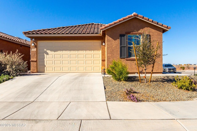 single story home featuring stucco siding, driveway, a tiled roof, and an attached garage