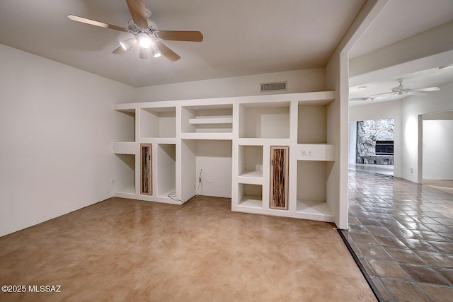 972 N Rancho Del Jefe Loop, Tucson, AZ 85748 - spare room with ceiling fan, a fireplace, built in shelves, and carpet