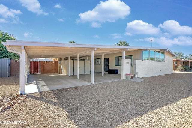 back of property with a carport