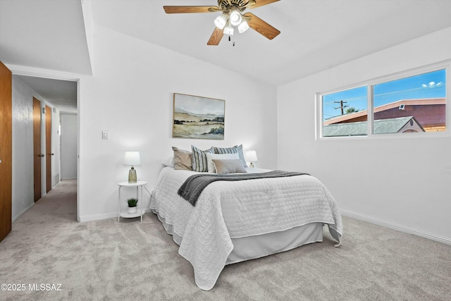 bedroom featuring light colored carpet and ceiling fan