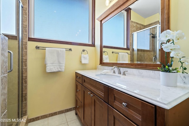 bathroom with vanity, a shower with shower door, and tile patterned floors