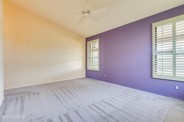 carpeted spare room with lofted ceiling and ceiling fan