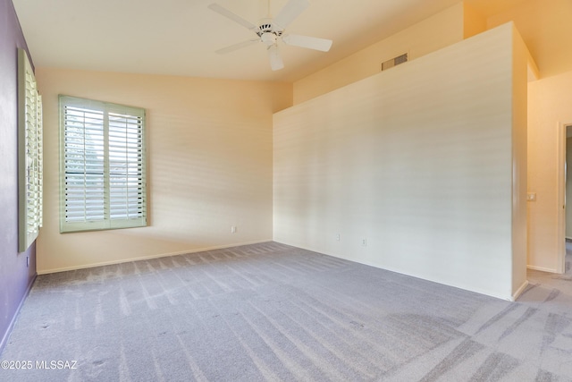 spare room featuring light carpet and ceiling fan