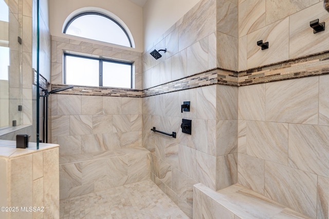 bathroom with a tile shower