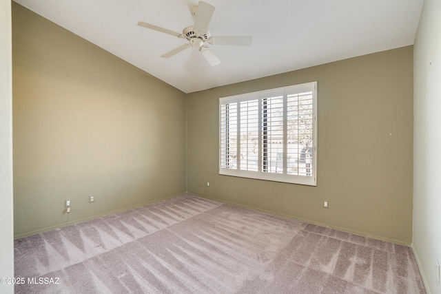 carpeted empty room featuring lofted ceiling and ceiling fan