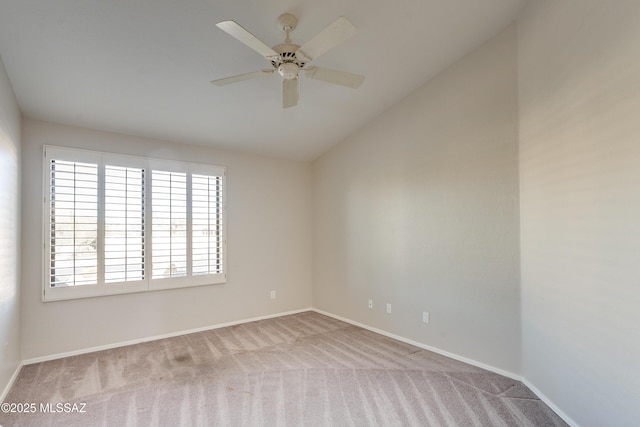 unfurnished room with vaulted ceiling, light colored carpet, and ceiling fan