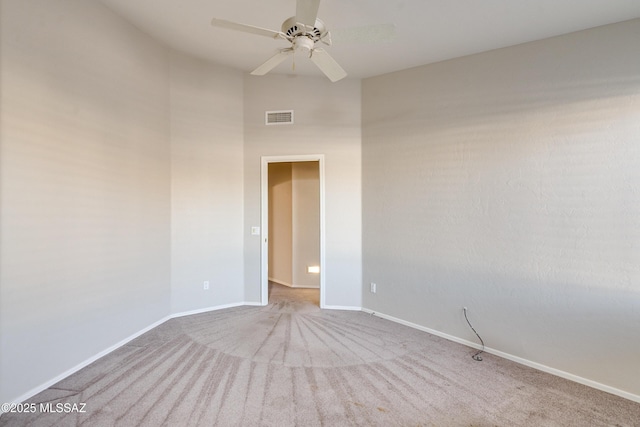 carpeted empty room featuring ceiling fan