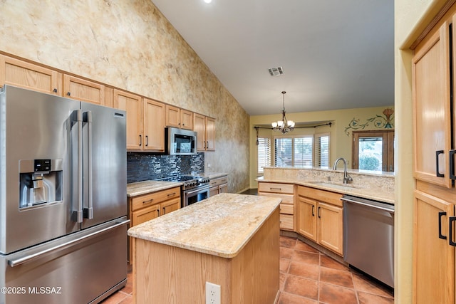 kitchen with a kitchen island, sink, kitchen peninsula, stainless steel appliances, and light brown cabinets