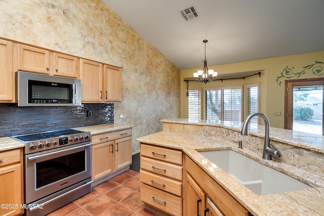 kitchen featuring tasteful backsplash, stainless steel appliances, light brown cabinetry, and sink