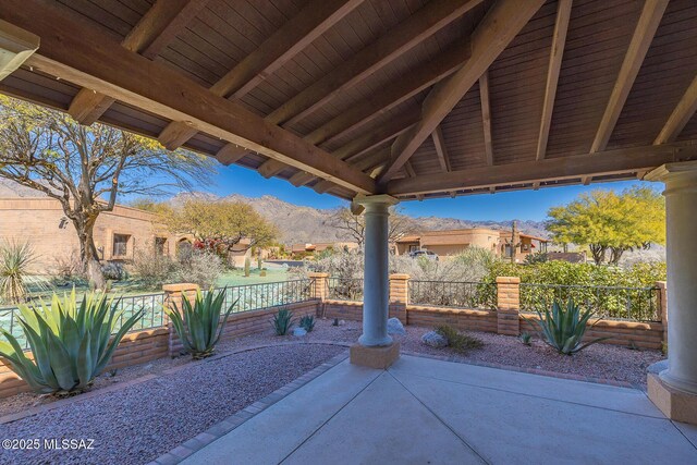 view of patio / terrace with a garage and a mountain view