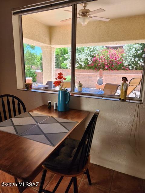 tiled dining room featuring ceiling fan