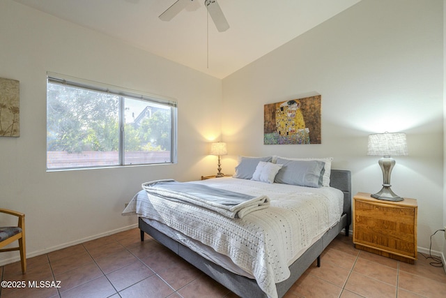 tiled bedroom with ceiling fan and vaulted ceiling