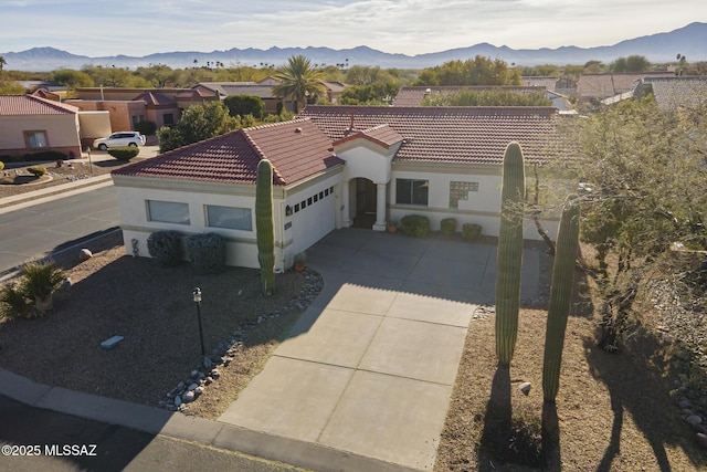 view of front of house with a garage and a mountain view