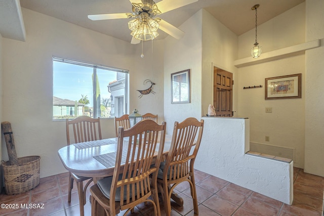 dining space with light tile patterned floors and ceiling fan